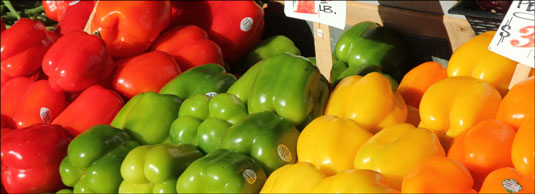 The peppers come to life as the sun bathes this outdoor market in late afternoon light.