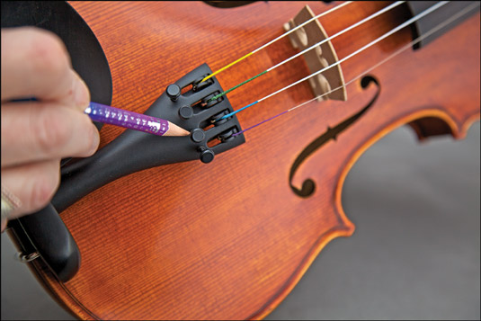 Using a soft pencil to help the fine tuners turn smoothly. [Credit: Photograph by Nathan Saliwonchy