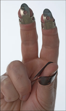 Proper positioning of the thumbpick and fingerpicks. [Credit: Photograph by Anne Hamersky]