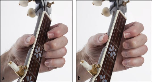 Playing a first‐string pull‐off: (a) fretting at the second fret and (b) pulling down w