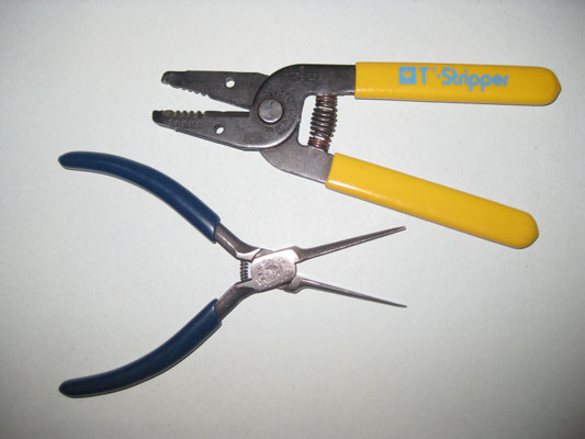 <i>Hand tools</i>: a gauged wire stripper/cutter and needle-nose pliers.