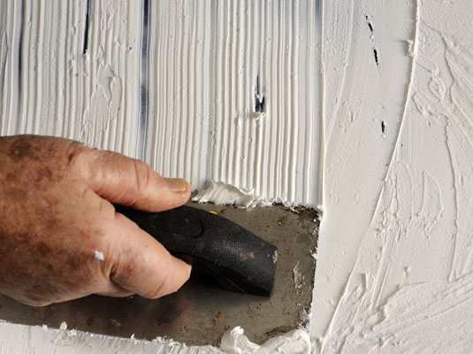 <b>Use a notched trowel to apply tile adhesive to the tabletop.</b>