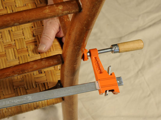 Clamp the chair rungs into place and wipe off any excess glue that oozes out.