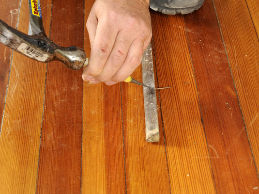 Position the pry bar as close to the nail as possible and use a hammer to help remove base shoe moldings. (Use a nail set to drive a stubborn nail through the molding.)