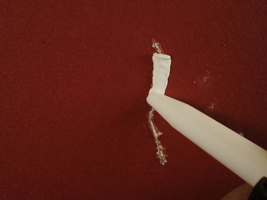 Apply a thin bead of caulk into the crack.