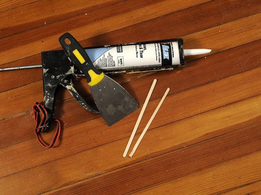 Gather your materials: a putty knife or scraper, a new tube of caulk, a caulk gun, and a flat craft stick