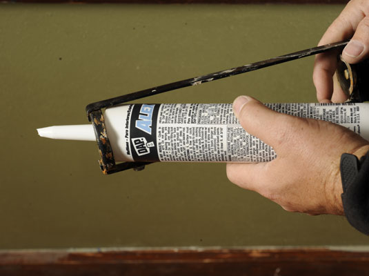 Load the tube into the caulking gun.