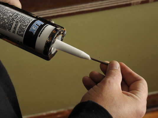 Cut off the tip of the tube of caulk and puncture the seal with a nail or stiff wire.
