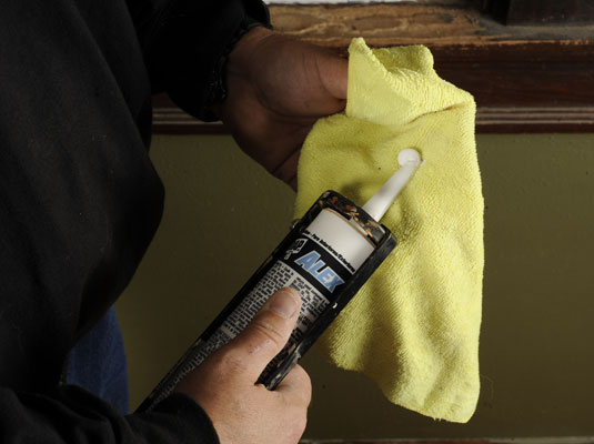 Clean the caulk tube with a damp rag.