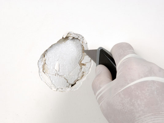 Use a sharp utility knife to trim away any loose or protruding paper facing or loose pieces of gypsum.