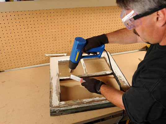 Use the heat gun to warm the old putty; and then scrape it away with a putty knife.