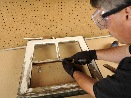 Use a putty knife or the tip of a screwdriver to remove the old glazing points.