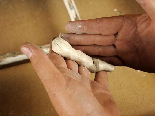 Form a 1/2-inch-thick rope of putty and press the length along all four sides of the glass.