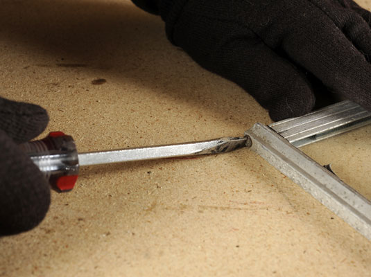 Use the screwdriver to remove each of the corner screws.
