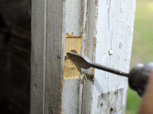 Bore a latchbolt hole in the center of the mortise.