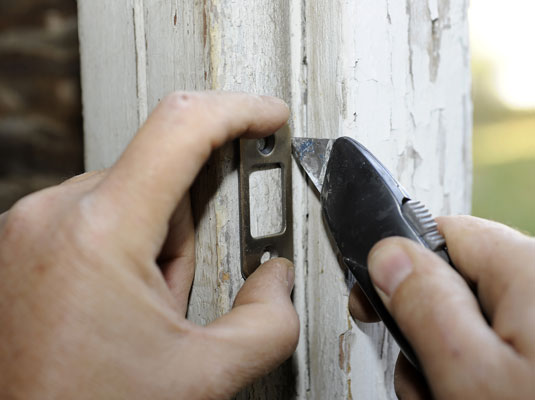 Mark the area around the strike plate that you want to install flush with the wood.