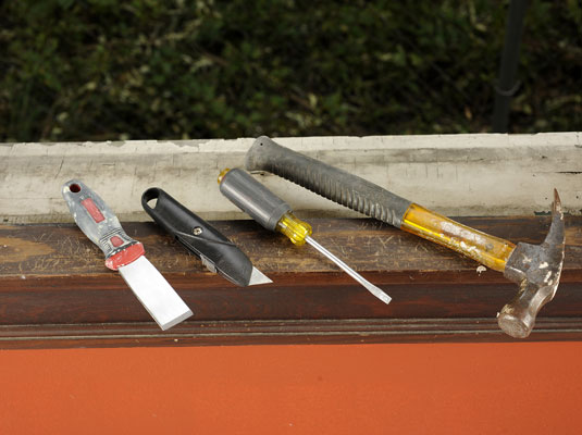 Gather your materials: Razor blade or utility knife, stiff putty knife, hammer, screwdriver.