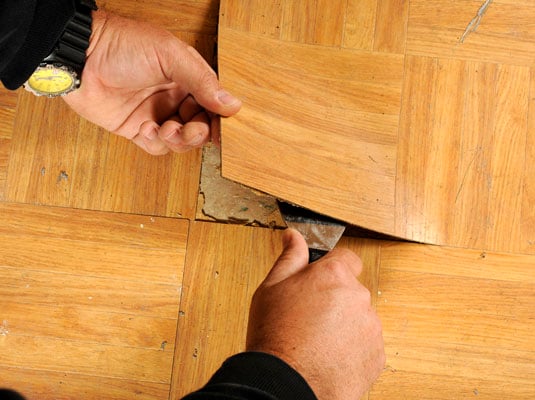 Lift out the old tile by using the putty knife.