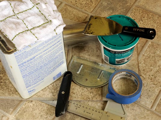 Gather your tools: Patch cut from scrap of vinyl flooring, masking tape, utility knife, putty knife, pencil, floor adhesive, T-square, mineral spirits, rags, rolling pin.