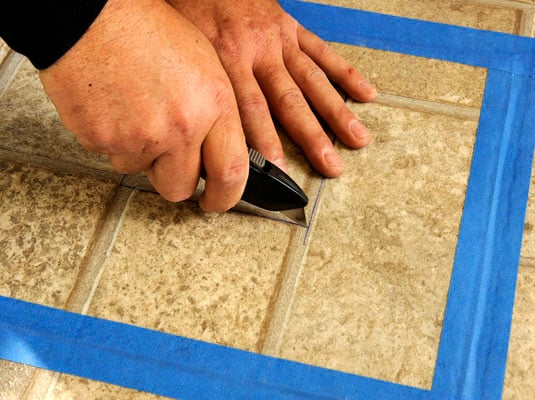 Cut through both layers of vinyl at once, the scrap and the flooring.