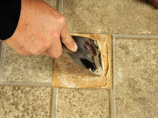 Scrape away the old adhesive.