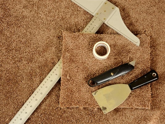 Gather your tools: Carpet remnant, roll of double-sided carpet tape, tube of seam adhesive, putty knife, utility knife, T-square.