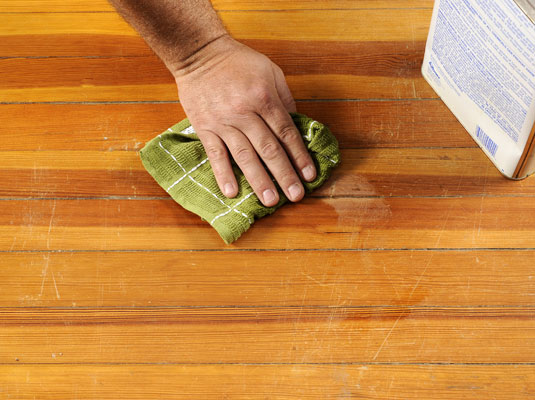 Rub mineral spirits over the sanded area.