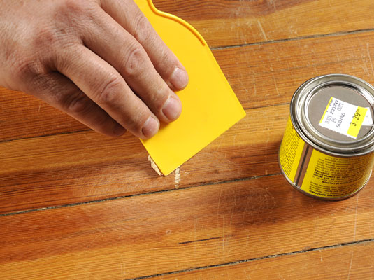 Fill the scratch with premixed wood filler.