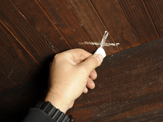 Have your helper walk across the floor looking for squeaks. Mark the spot with chalk.