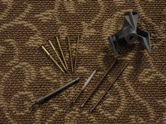 Gather your materials: Hammer, sticky notes or masking tape, drill, carpet repair kit.