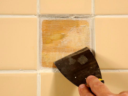 Scrape away the old adhesive.