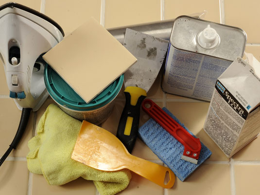Gather your materials: Tile cutter, replacement tile, grout, an iron, tile adhesive, putty knife, mineral spirits, rags, sponge, rolling pin.