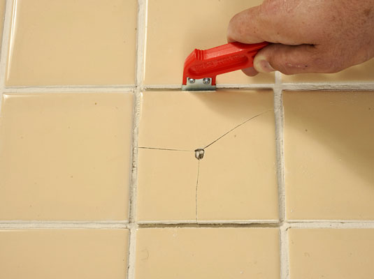 Cut between the tile and the grout by using the tile cutter.