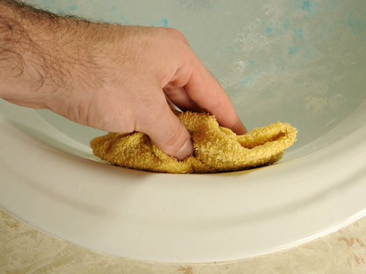 Use a wet rag or sponge to block up the overflow hole.