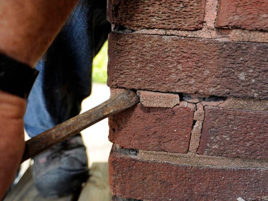 Chisel out any loose mortar.