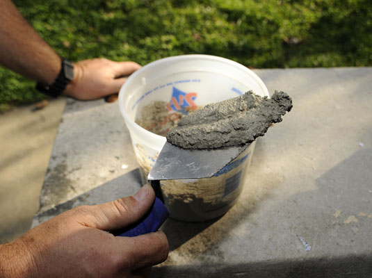 Load some mortar on the trowel.