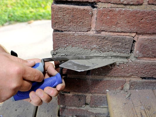 Push the mortar in between the brick.