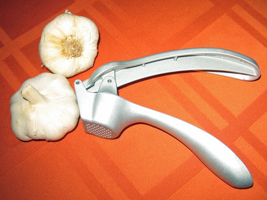 Mince the clove (chop it into really tiny pieces) or put it in a garlic press.