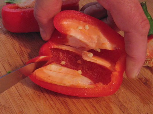 Cut the pepper in half and remove the white ribs.