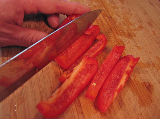 Cut the pepper halves into lengthwise strips.