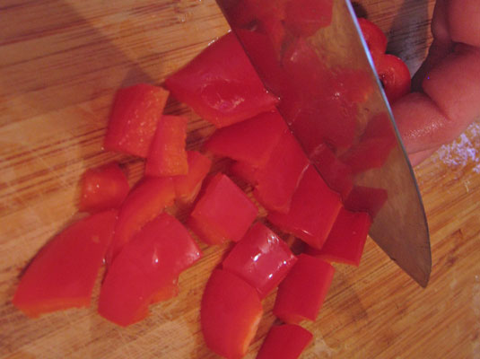 If you want to cut the pepper into cubes, hold the strips together and cut crosswise.