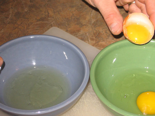 When all the white is in the bowl, carefully transfer the yolk to the other bowl.