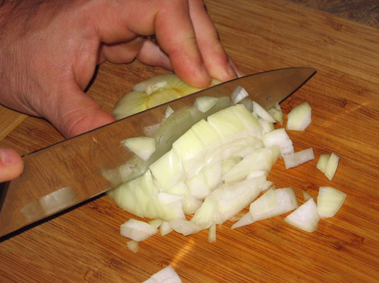 Cut through the vegetable at right angles to the board.