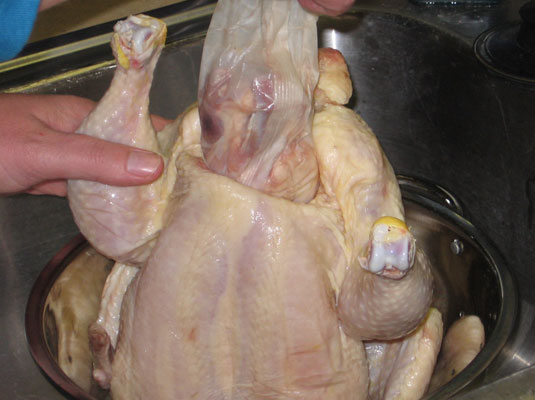 Remove the packaged giblets (the neck, heart, gizzard, and liver) inside the chicken’s cavity.