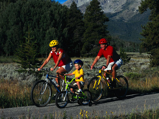 Biking together is one way to be a green family. [Credit: Corbis Digital Stock]