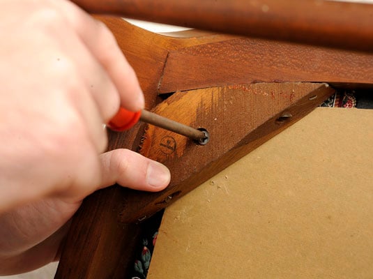 Remove the seat pad from the chair by removing the screws that hold it to the frame.