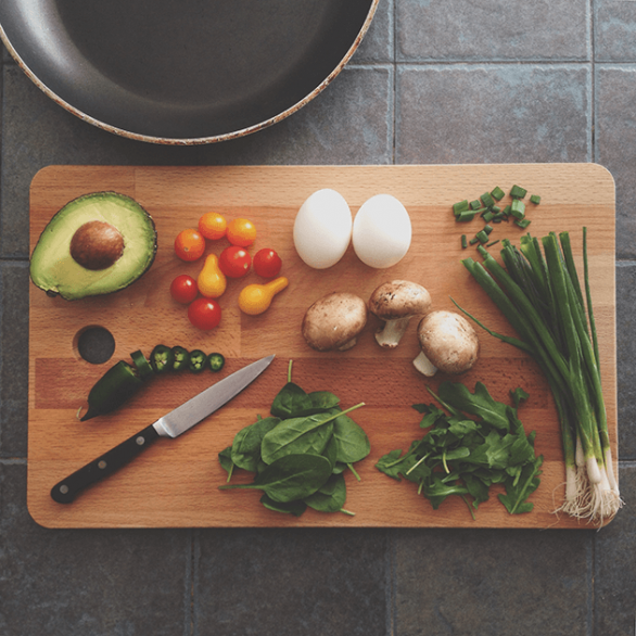 Cutting board with knife and vegetables