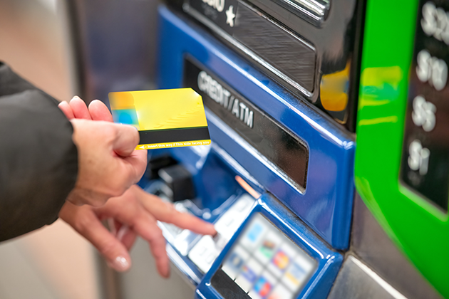 Hand putting card into ATM