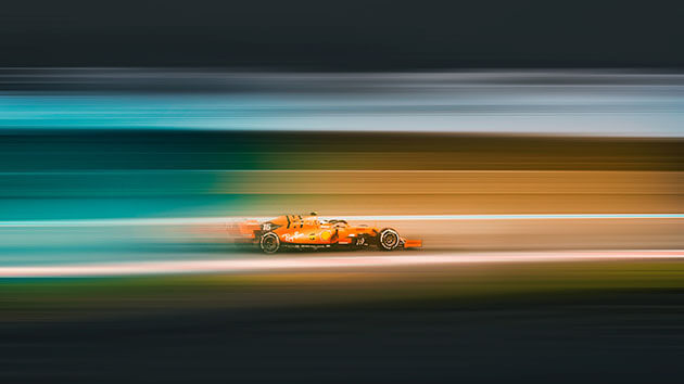 Orange Formula One racing car with a blurred background