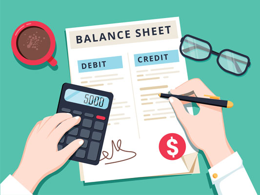 bookkeeper working with balance sheet